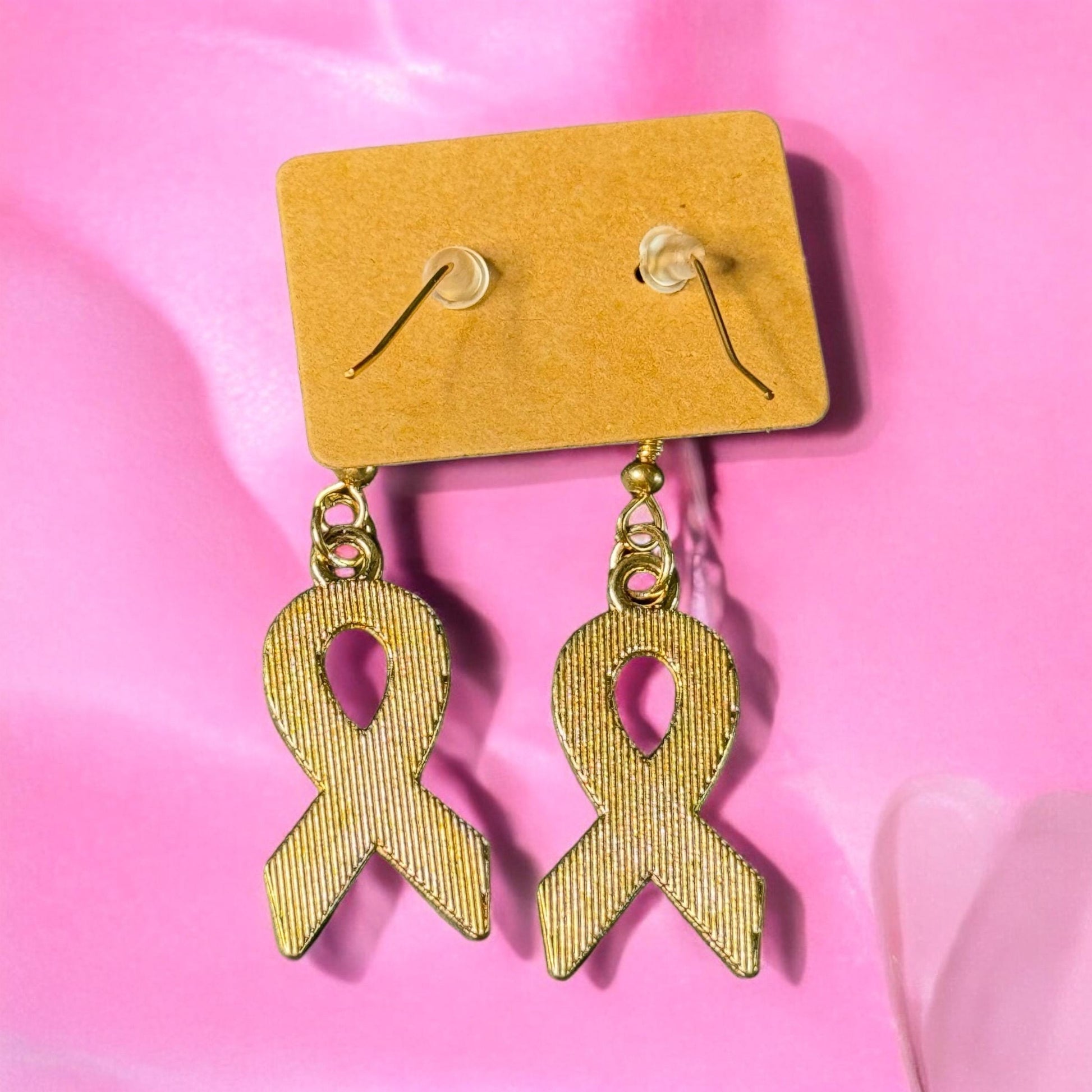 Gold metal backing of breast cancer ribbon dangle earrings.