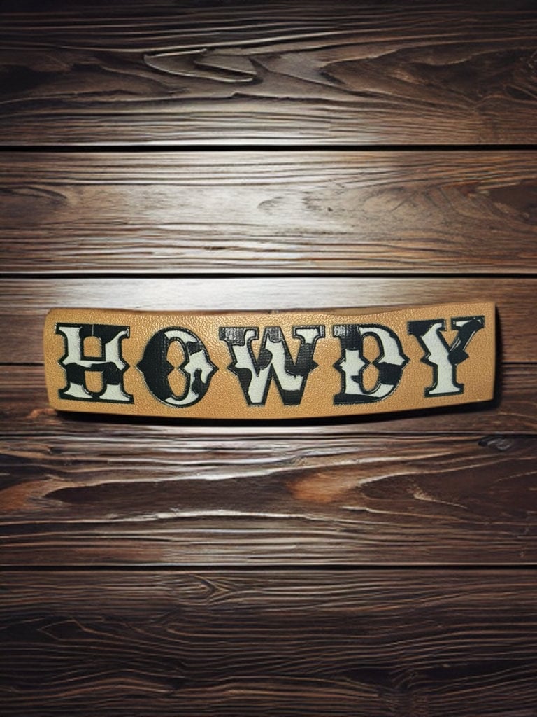 FAUX LEATHER COW PRINT HOWDY BARRETTE