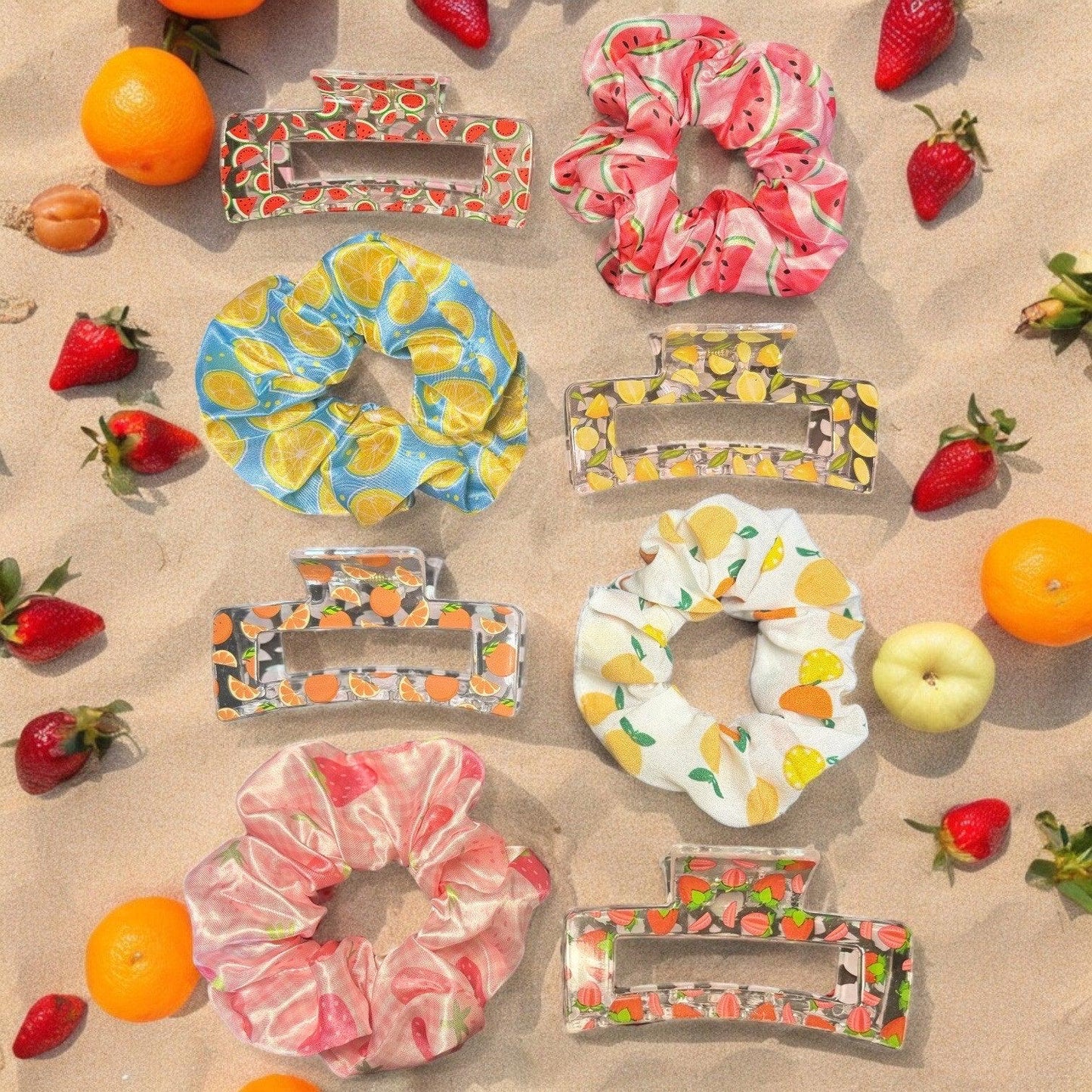 4 pairs of claw clips and scrunchies. One pair is a watermelon print hair claw and scrunchie, one pair is a lemon print hair claw and scrunchie, one is an orange print hair claw and scrunchie, and the last is a strawberry print claw and scrunchie.